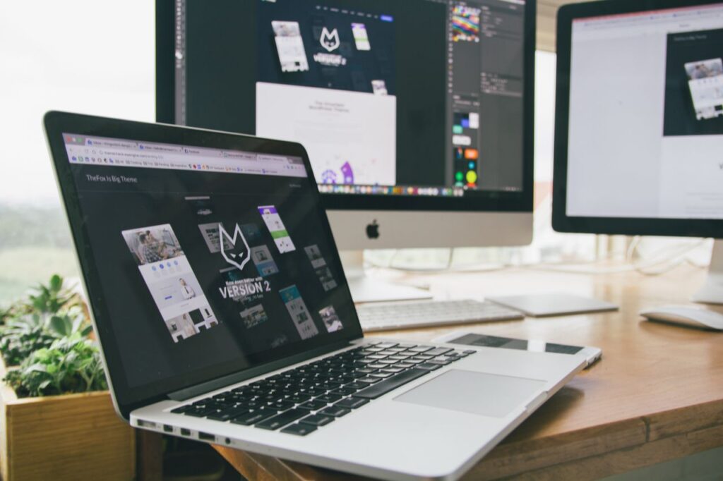 Crafting Captivating Headlines: Your awesome post title goes here A stylish workspace featuring a laptop and monitors displaying design software.